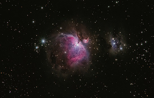 Image of purple Nebula in space surrounded by stars.