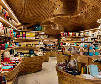 Shelves that are filled with items and gifts in a large modern wooden shop.